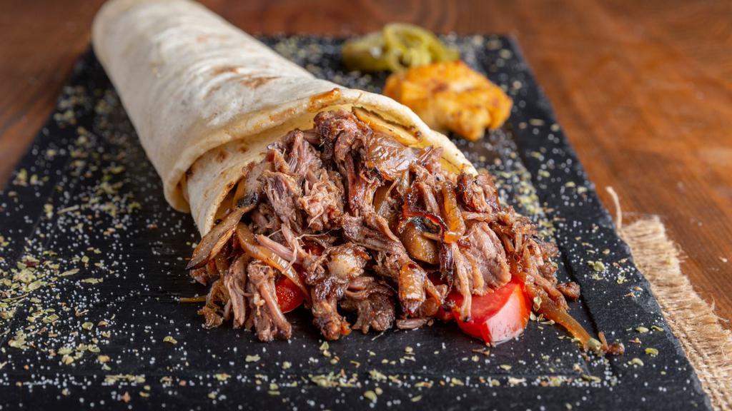 Super Carnitas (Pulled Pork) Burrito · A mouthwatering Super Burrito made with a Flour tortilla and filled with Pulled Pork, rice, beans, salsa, avocado, sour cream, and cheese.