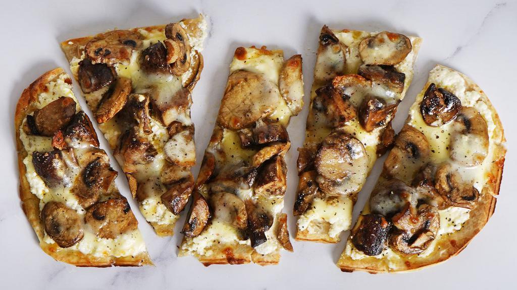 Mushroom · Our classic flatbread brushed with decadent cream sauce, mozzarella, mushrooms and herbs.