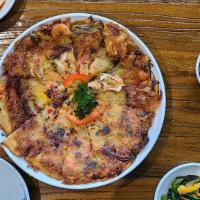 Seafood Pa-Jeon · Traditional Korean style pancake with green onion and assorted seafood.