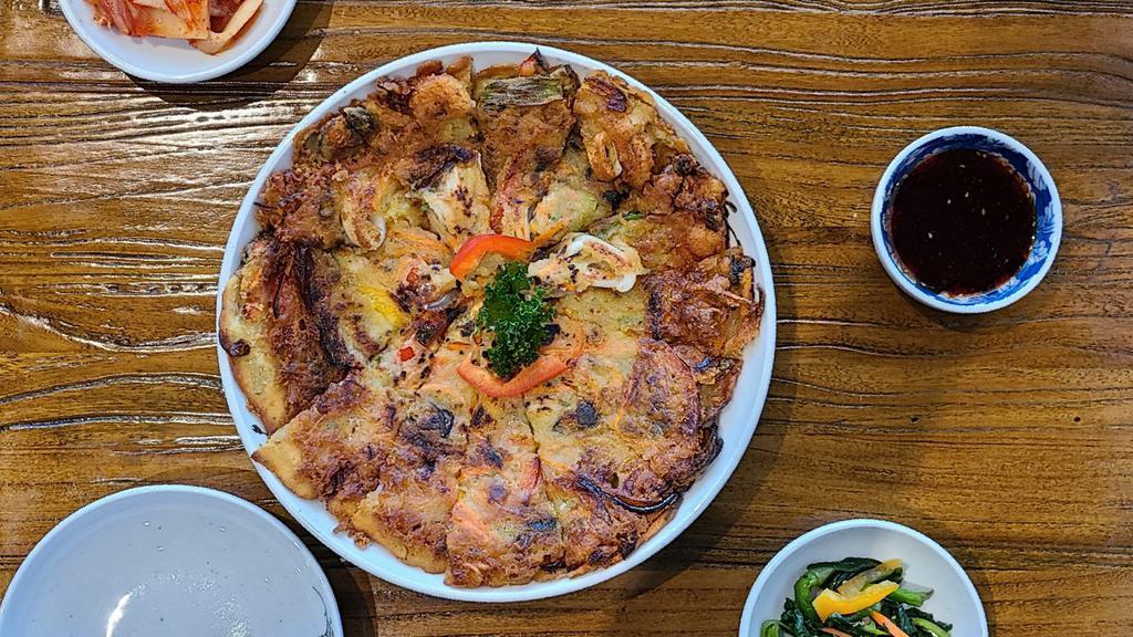 Seafood Pa-Jeon · Traditional Korean style pancake with green onion and assorted seafood.