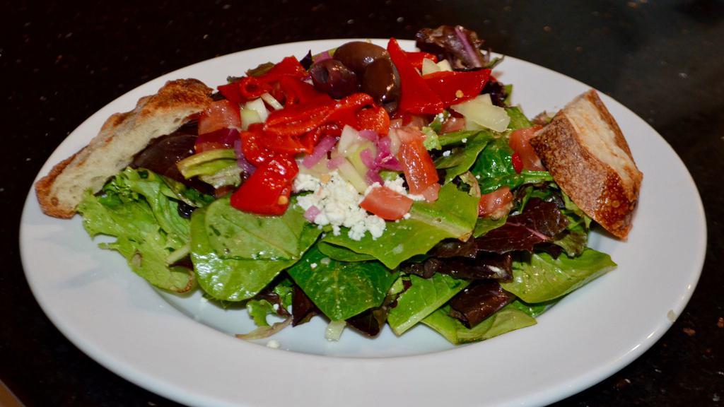 Mediterranean Salad · Mixed greens, crumbled feta cheese, red onions, cucumbers, tomatoes, and black cured olives with a Greek dressing.