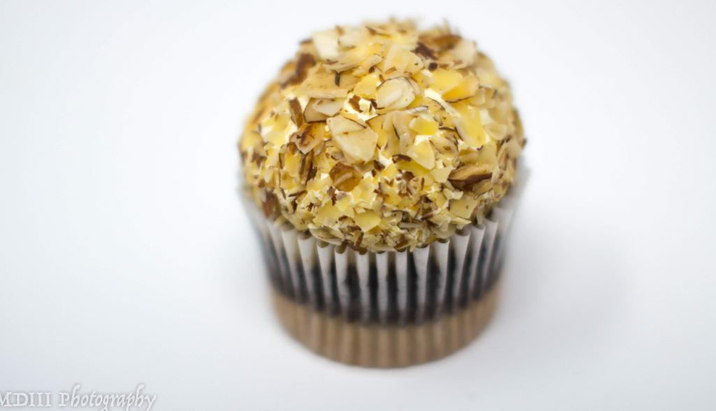 Burnt Almond · Marble cupcake with vanilla custard and roasted almonds on top.