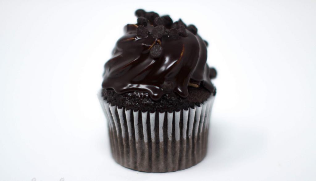 Chocolate Ganache Cupcake · Chocolate cake, topped with chocolate whipped cream and dipped in chocolate ganache and Halloween Decoration