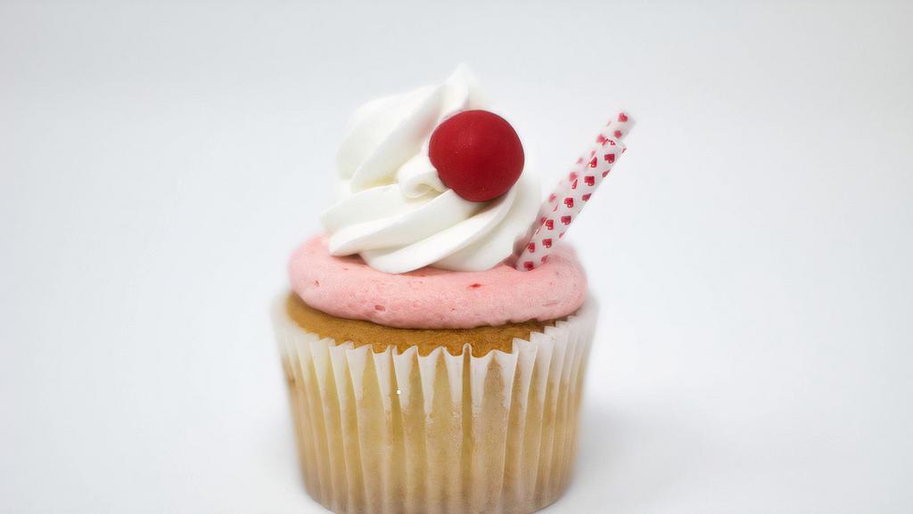 Strawberry Milkshake Cupcake · Vanilla cupcake with strawberry whipped cream frosting, a dollop of buttercream, with red gumballs + red paper straw to resemble an old school favorite.