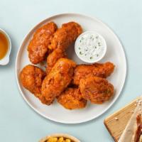 Hot Mama Mango Wings · Deep-fried wings tossed in mango habanero, served with a side of ranch dressing.