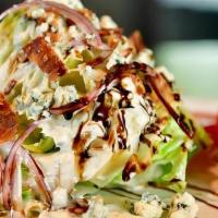 Wedge Salad · Bacon, tomatoes, red onion, danish blue cheese crumbles, side of blue cheese dressing and ba...