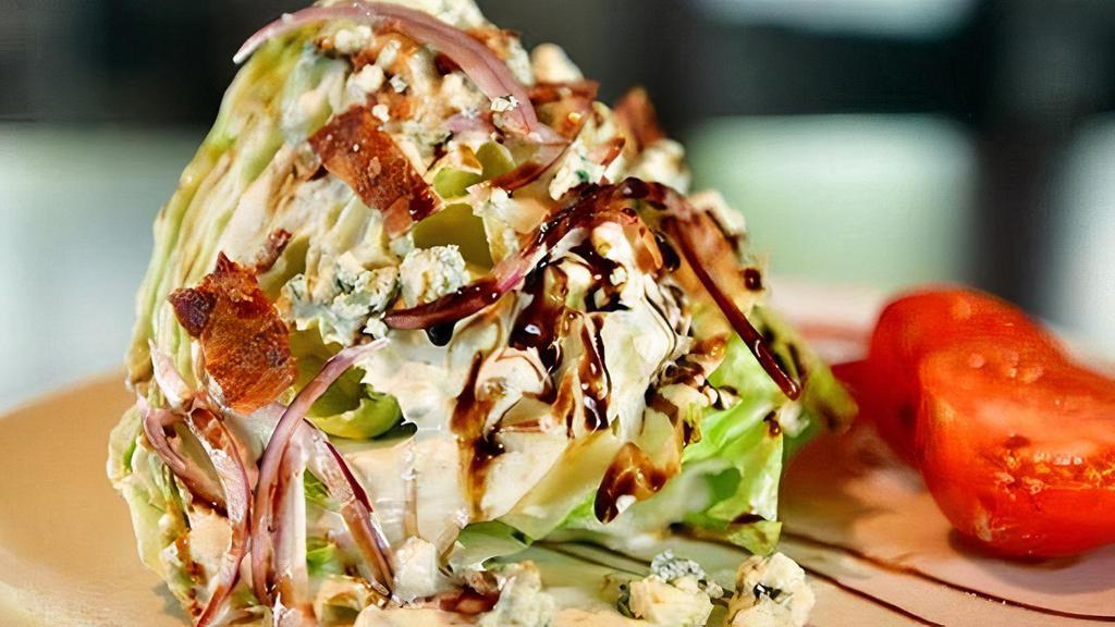 Wedge Salad · Bacon, tomatoes, red onion, danish blue cheese crumbles, side of blue cheese dressing and balsamic glaze.