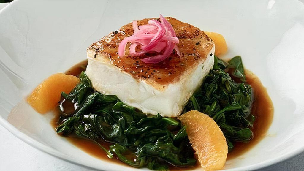 Miso Glazed Chilean Sea Bass · Sautéed with sesame-orange arugula, pickled red onion.