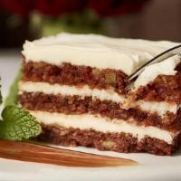 Carrot Cake · Three-layer cake with cream cheese frosting, drizzle of caramel