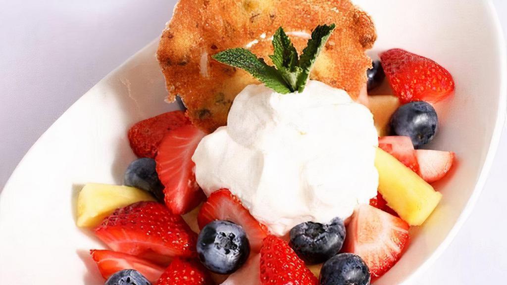 Fresh Fruit & Chantilly Cream · Mixture of strawberries, blueberries, pineapple topped with housemade chantilly whipped cream & pistachio tuille.