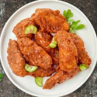 Hot Shot Wings · Fresh chicken wings breaded and fried until golden brown and tossed in hot sauce. Served wit...