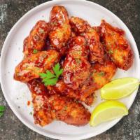 Crazy Cajun Wings · Fresh chicken wings breaded and fried until golden brown and tossed in cajun sauce. Served w...