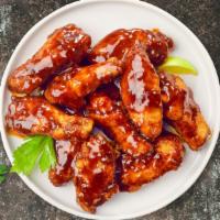 Smoking BBQ Chicken Wings · Fresh chicken wings breaded and fried until golden brown and tossed in BBQ sauce. Served wit...