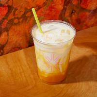Mango Lassi · A yogurt based drink, topped with fresh mango puree.