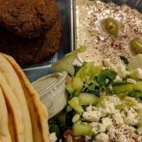 Falafel Platter · Fresh in house made falafel served with hummus, Greek salad, pita bread, tzatziki and chutne...