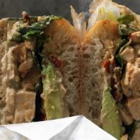 Jane Vegan Sandwich · Served with marinated tofu, tahini dressing, hummus, avocado, arugula cucumber, and sun-drie...