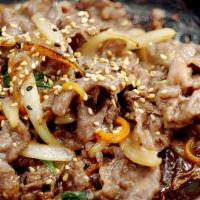 Bulgogi Marinated USDA Ribeye | 불고기 · Comes with steamed rice and different side dishes.