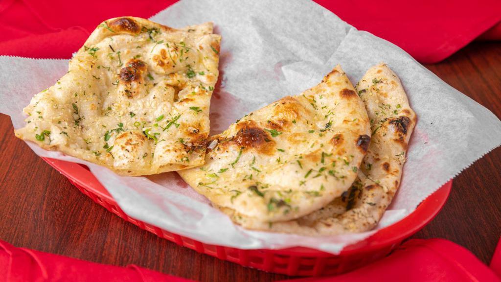 Garlic Naan · Flatbread cooked in a clay oven seasoned with garlic.