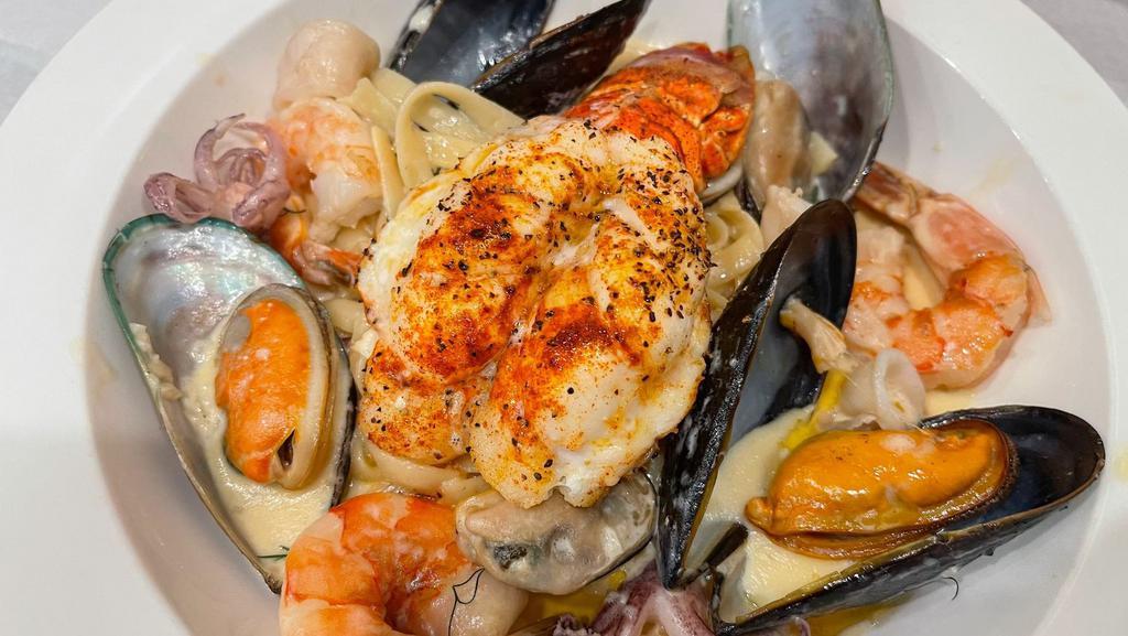 Fettuccine Fruitti Di Mare & Lobster · Fresh Fettuccine Pasta In lobster bisque sauce with mussels, prawns, and calamari. Served alongside a tender and flavorful lobster tail.
