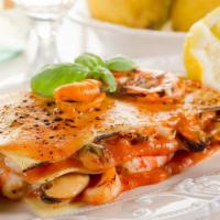 Seafood Lasagna · Made with Shrimp, White Fish, Scollops, garlic, Onion in a Lobster Sauce