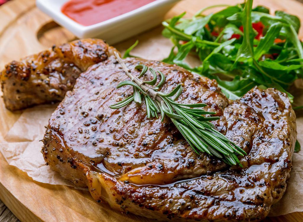 Ribeye Steak · Grilled Ribeye Steak Marinated with Garlic, Rosemary, Sage, Olive Oil, Salt Pepper served with Mash Potatoes, garlic Vegetables, and your Choice of Sauce