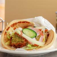 Falafel Gyro · Veggie Falafels wrapped in a fluffy pita bread with lettuce, tomatoes, onion, and tsaziki sa...