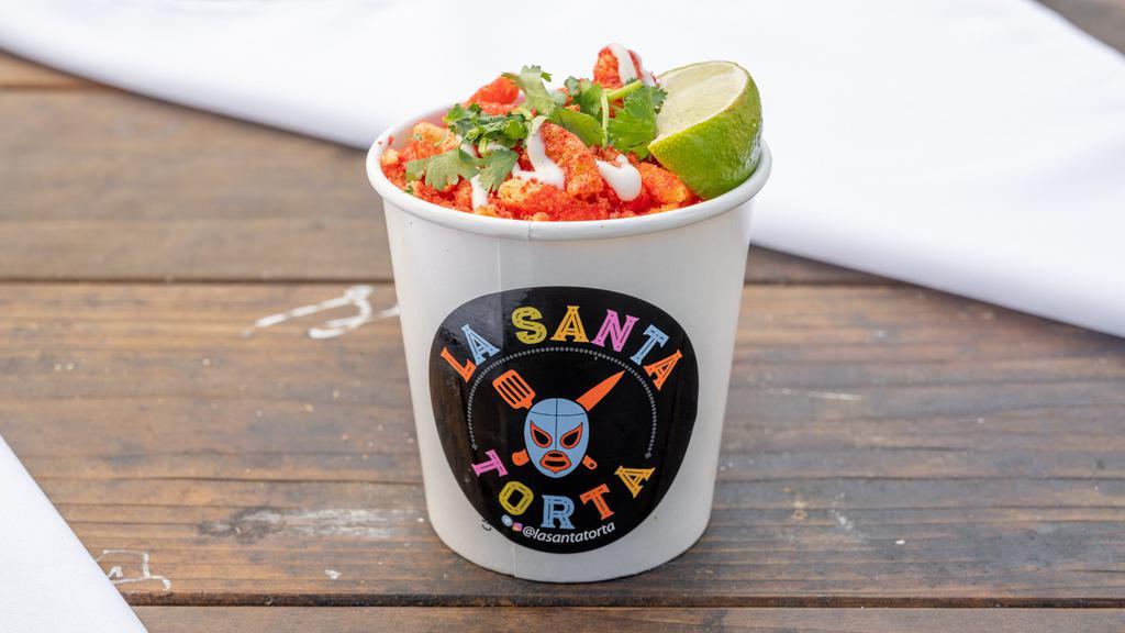 Elotes Chidos · Corn in a cup, mayo, cotija cheese, lime juice, tajin, tapatio and flaming hot cheetos.