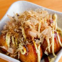 Takoyaki · Ball-shaped snack filled with diced octopus and served with house sauce.