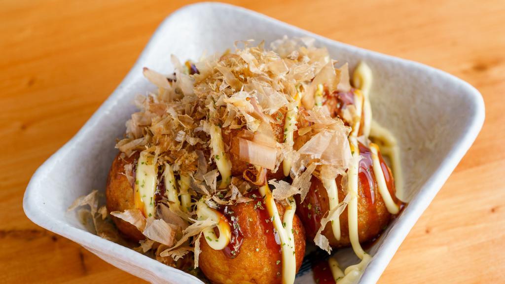 Takoyaki · Ball-shaped snack filled with diced octopus and served with house sauce.