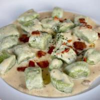 GNOCCHI · Homemade potato spinach gnocchi, butter, Italian. pancetta, truffle cream sauce, Grana Padano