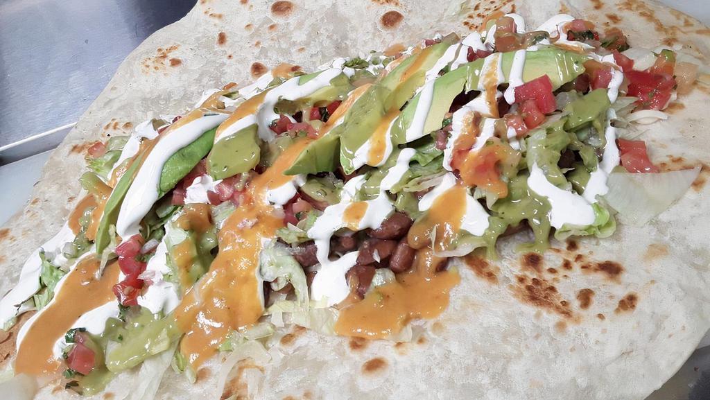 Burrito Vegetariano · Rice, Beans, Cheese, Cream, Grilled Bell Peppers, Grilled Mushrooms. Grilled Onions, Lettuce, Avocado