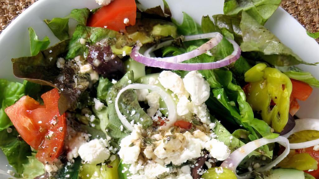 Greek Salad · Romaine Lettuce, Olive Oil, Red Onions, Green Olives, Sliced Cucumbers, Tomatoes, Oregano, Black Peppers, Splash of Lemon Juice, Red Bell Peppers, Feta Cheese. Served with Balsamic Vinaigrette.
