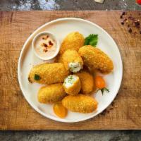 Papa Peno Poppers · Fresh jalapenos coated in cream cheese and fried until golden brown.