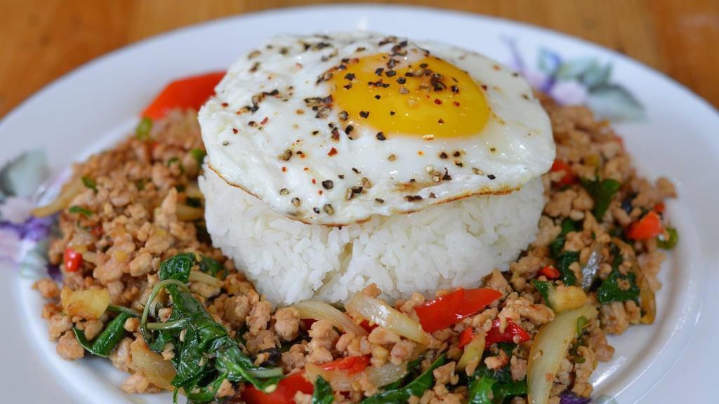 Basil Chicken (Pad Ka Prow) · Jasmine rice with ground chicken, basil leaves, Thai chili, garlic, onion, bell pepper, fried egg on top.