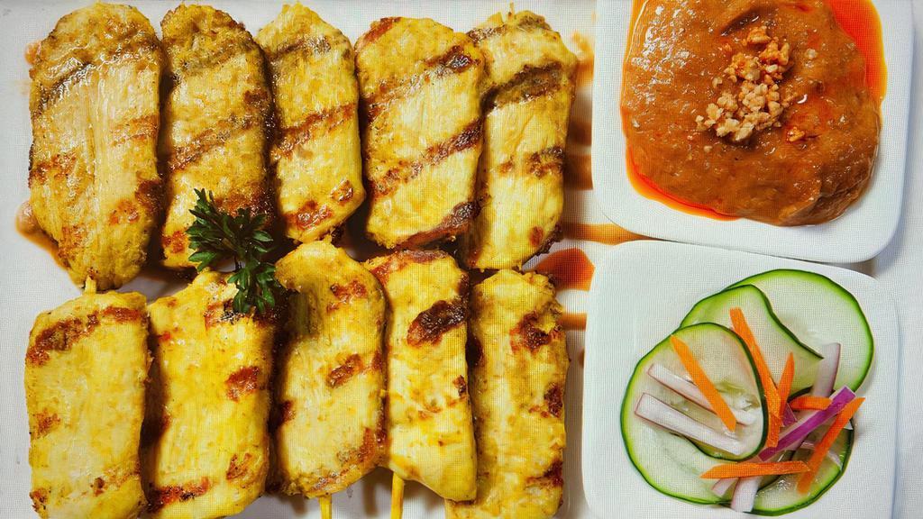 Chicken Satay · Grilled marinated sliced chicken breast on skewers. Served with cucumber salad and peanut sauce.