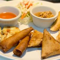 Combo-Appetizer · Two pieces of pork spring rolls, chicken satay, prawn rolls, and samosas.