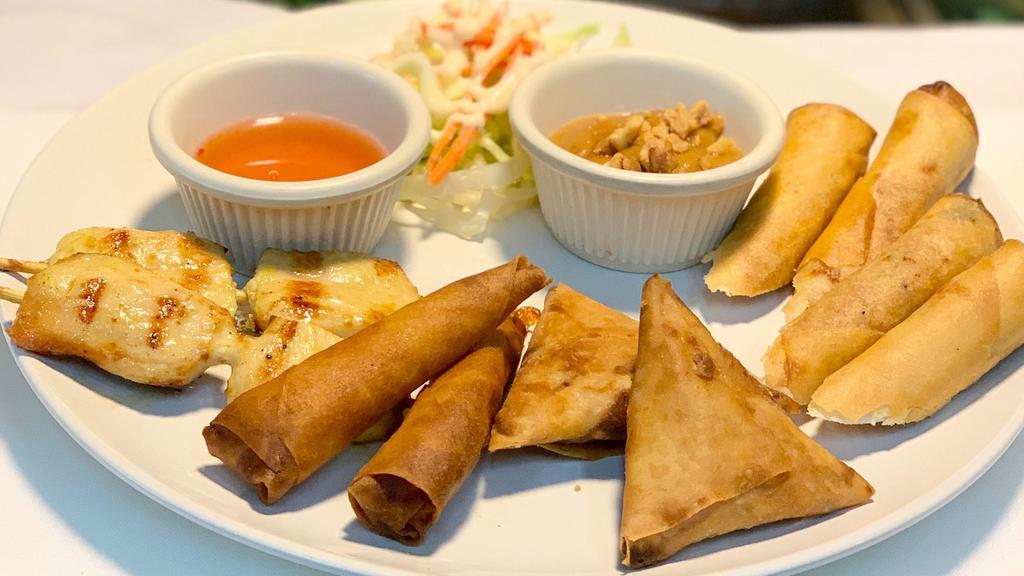 Combo-Appetizer · Two pieces of pork spring rolls, chicken satay, prawn rolls, and samosas.