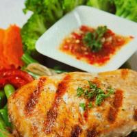Grilled Salmon · Grilled marinated salmon fillet. Served with spicy chili garlic sauce and steamed vegetables.