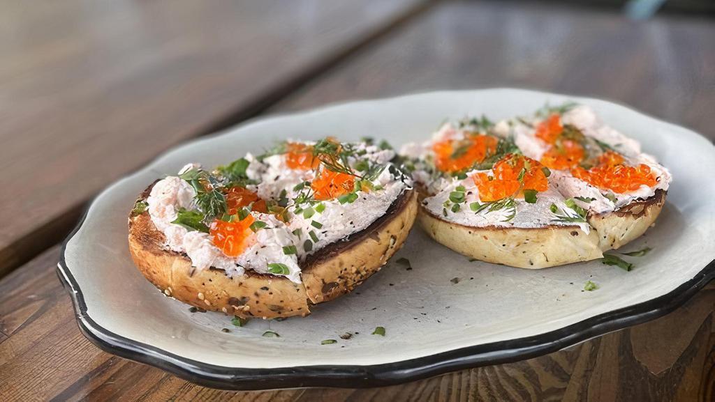 Smoked Trout Dip Bagel · Everything bagel, hot smoked trout dip, . trout roe, herbs