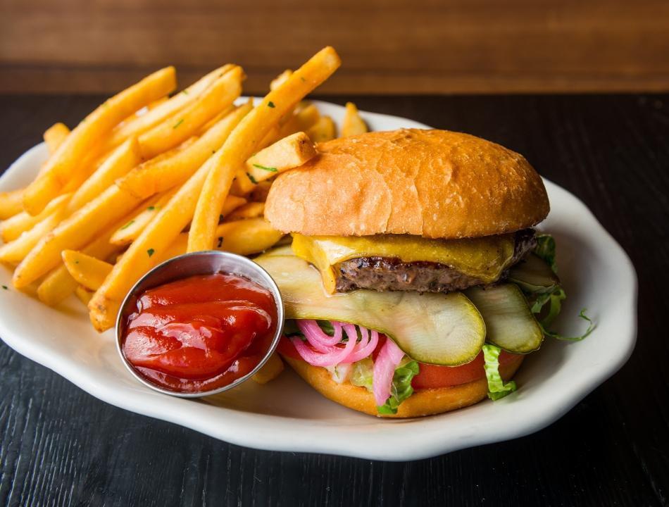 Americana Burger · beef patty, cheddar cheese, lettuce, tomato, pickled onions, pickles, and mayo on a bun. Served with french fries. Comes cooked medium.