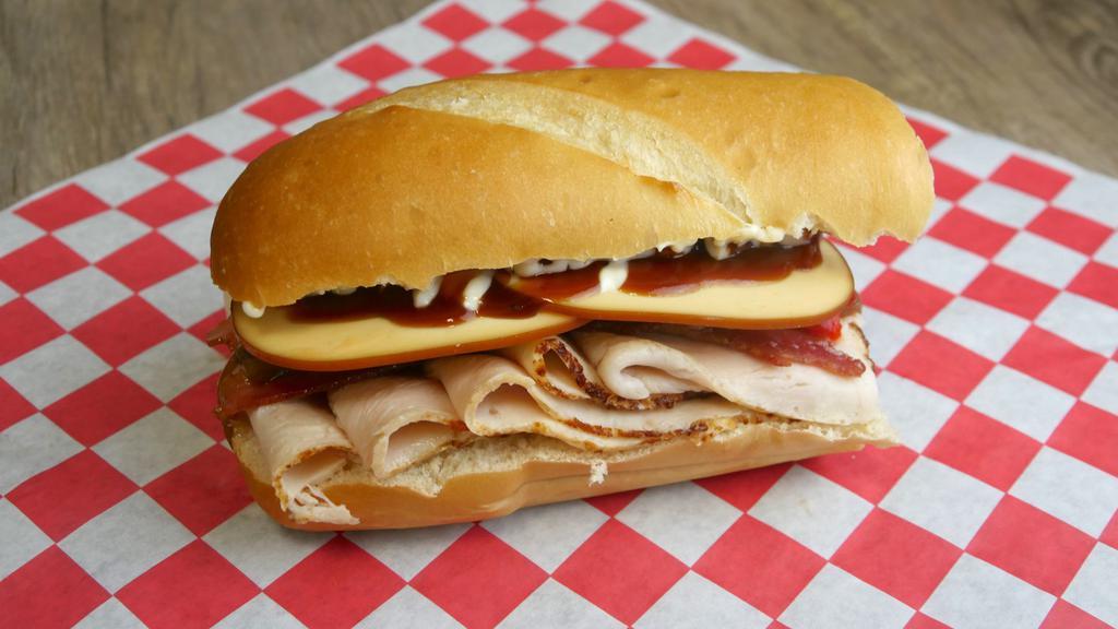 6. Smoke Jumper · Smoked turkey, bacon, smoked Gouda cheese, roasted red peppers, caramelized onion, mayo, BBQ sauce.