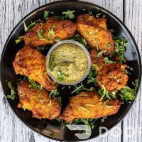 Karahi Wings (Bone-in) · Spicy Chicken Wings marinated in our savory Masala Mix topped with Fresh Lemon and Cilantro.