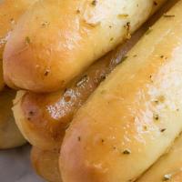 Garlic Bread Sticks · Our garlic bread sticks are sprinkled with parmesan and parsley and served with marinara.