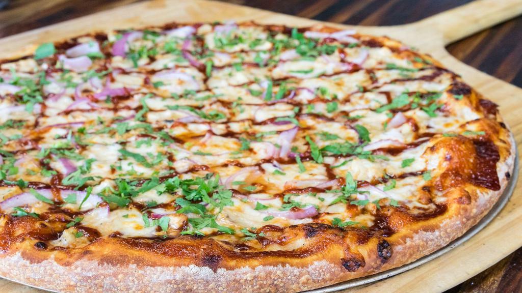 BBQ Chicken · Our classic house made beer crust on BBQ Sauce with grilled chicken breast, grilled onions, cilantro and mozzarella cheese. One of our best sellers.