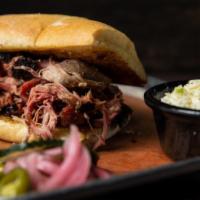 Regular Pulled Pork · Slow cooked for several hours and served with our vinegar molasses hog wash. Served with you...