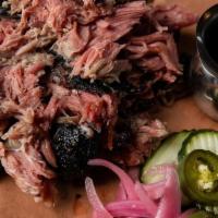 Pulled Pork Half Lb · Slow cooked for several hours, served with our vinegar molasses hog wash