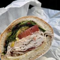 The Alpino Sandwich · Oven Roasted Turkey, Bacon, Swiss Cheese with Organic Mixed Greens, Tomato, Pepperoncini, Bl...