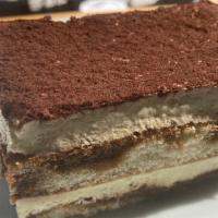 TIRAMISU · Two layers of espresso drenched sponge cake divided by mascarpone cream, dusted with cocoa p...