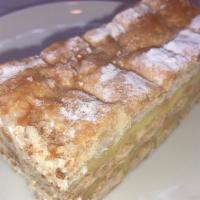 NAPOLEON · Crisp layers of puff pastry filled with pastry cream & decorated with powered sugar.
