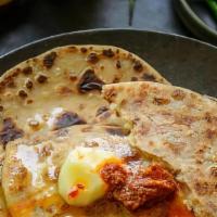 Aloo Paratha · Wheat bread stuffed with potato, peas, spices and butter.